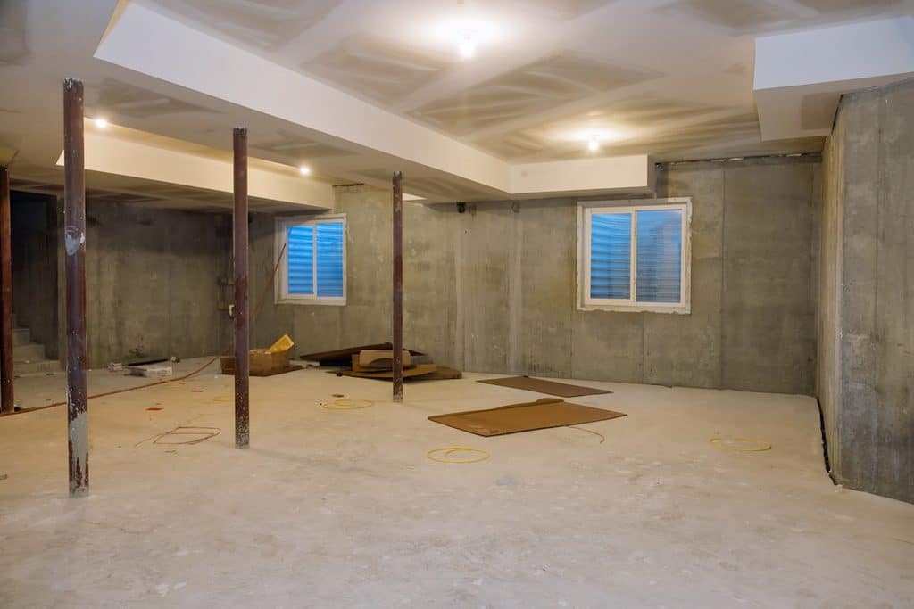 Basement wall reinforced with carbon fiber straps for foundation repair